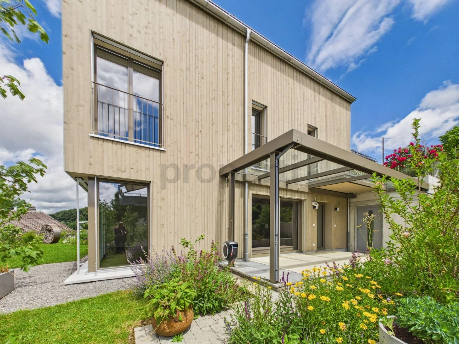 Stylish new single-family house in sustainable timber construction with natural garden and Alpine view