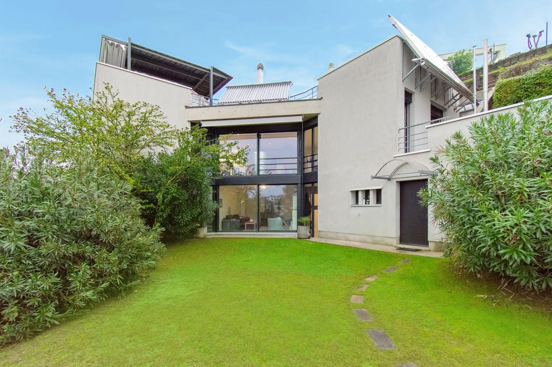 Modern two-story house with garden and terrace